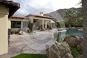 Swimming pool in luxurious mansion with mountain in background