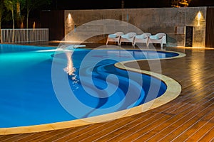 Swimming pool at a luxury Caribbean, tropical resort at night, dawn time.