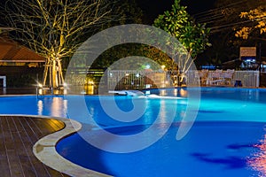 Swimming pool at a luxury Caribbean, tropical resort at night, dawn time.