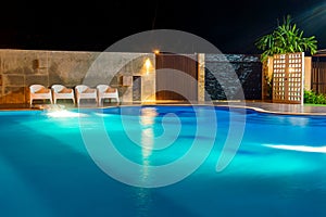 Swimming pool at a luxury Caribbean, tropical resort at night, dawn time.