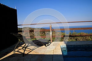 Swimming pool of luxury holiday villa, amazing nature view landscape sea. Relax near swimming pool with handrail, deck chairs.