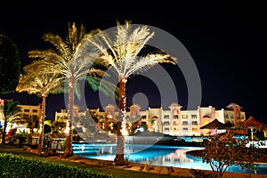 The swimming pool at luxury hotel in night illumination