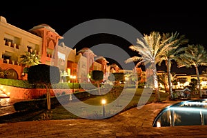 The swimming pool at luxury hotel in night illumination