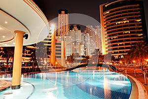 The swimming pool at luxury hotel in night illumination