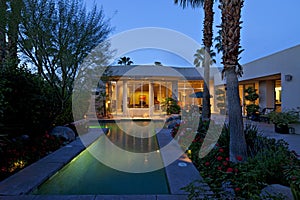 Swimming pool outside mansion at dusk