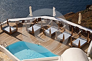 A Swimming Pool Overlooks the Santorini Caldera photo