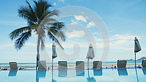 Swimming pool with palm tree near the sea on Koh Samui