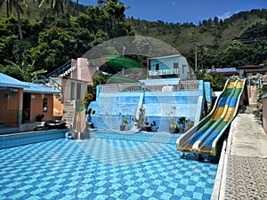 swimming pool rides equipped with straight, elongated water slides and twisty slides.