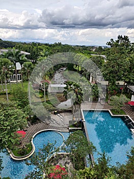 Swimming pool and river, garden and jungle in luxury Hotel