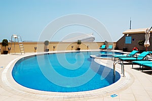 Swimming pool on the roof of luxury hotel with view on Ski Dubai