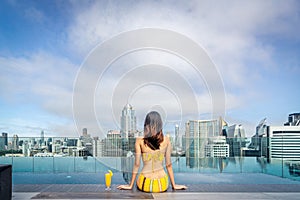 swimming pool and roof top bar on hotel deck in Bangkok city