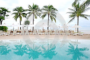 Swimming pool by sea at resort hotel