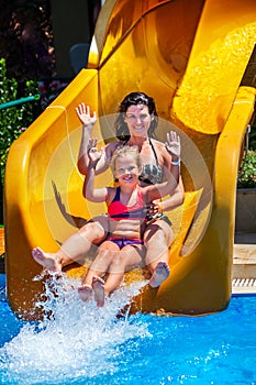 Swimming pool slides for family with children on water slide at aquapark .