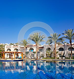 Swimming pool with the some beach lounges