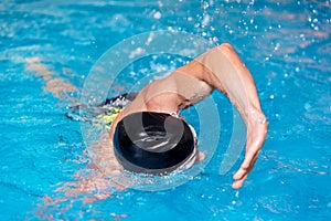 Swimming pool sport crawl swimmer. Man doing freestyle stroke technique in water pool lane training for competition.