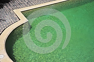 Swimming pool steps with clear water surface background, nobody. Abstract pool texture, underwater pattern blue background with