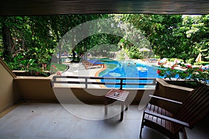 Swimming pool, sun loungers next to the garden and buildings