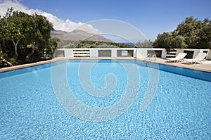 Swimming pool with sunbeds and landscape
