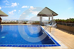 Swimming pool with sunny reflections on good weather day. Relax time with family on swimming pool. Popular sport