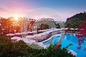 Swimming pool with sunshades and lounge chair