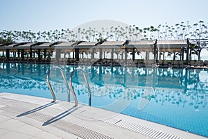 Swimming pool with sunshades and lounge chair