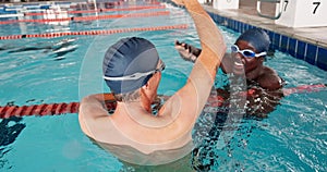 Swimming pool, swimmer and high five in professional, gym and practice for competition as athlete or training. Aquatic