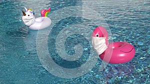 Swimming pool toys unicorn and flamingo in a medical face mask