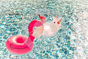 Swimming pool toys unicorn and flamingo in a medical face mask