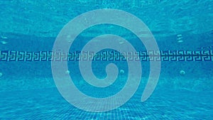 Swimming pool underwater, blue water background with copy-space