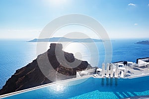 Swimming pool with a view on Caldera over Aegean sea, Santorini, Greece