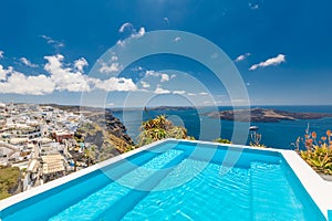 Swimming pool with a view on Caldera over Aegean sea, Santorini, Greece at hot sunny summer day