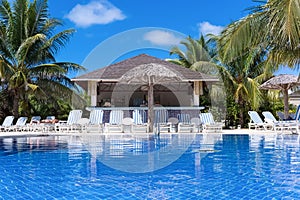 Swimming pool view with sun lounger and a bar in Cuba