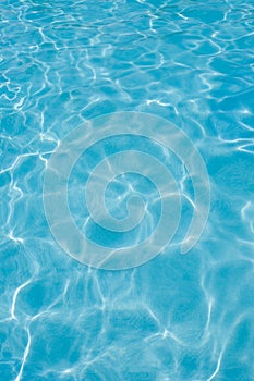 Swimming pool water surface, sunlight reflections