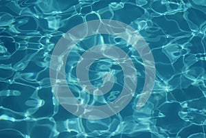 Swimming pool water texture in abstract style on a blue background.