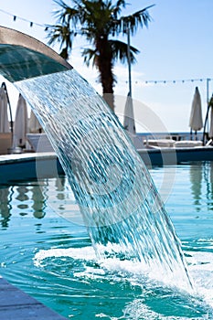 Swimming pool waterfall jet