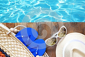 Swimming pool and wooden deck with beach accessories