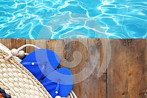 Swimming pool and wooden deck with beach accessories