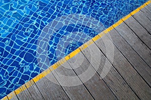 Swimming pool and Wooden flooring beside the pool ideal for backgrounds