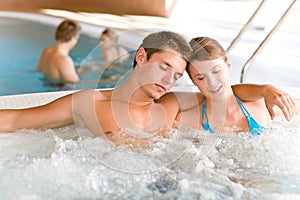 Swimming pool - young couple relax in hot tub