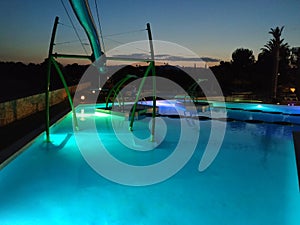 Swimming pools illuminated at night in a tourist complex on the Mediterranean coast