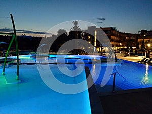 Swimming pools illuminated at night in a tourist complex on the Mediterranean coast