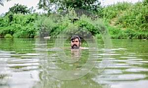 Swimming skills. Refreshing feeling. Man enjoy swimming in river or lake. Submerge into water. Freshness of wild nature