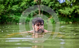 Swimming sport. Swimming skills. Refreshing feeling. Man enjoy swimming in river or lake. Deep dangerous water. Submerge