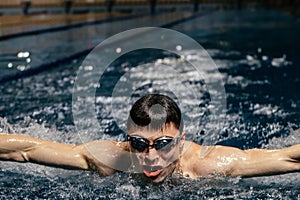 Swimming sports athlete swimmer swims in the pool, preparing for the race. Professional men& x27;s water sports for adults