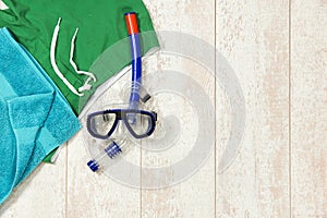 Swimming Trunks, Towel And Snorkeling Mask On Floorboard