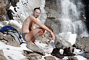 Swimming in winter waterfall