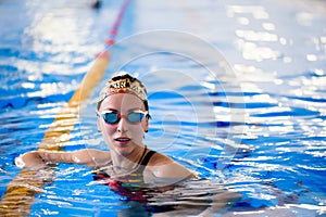 Swimming workout in the sports pool. The coach shows a swimming master class.