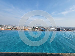 Swimmingpool view with morning sunshine on the top building