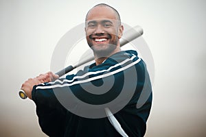 Swing batter batter. Cropped portrait of a handsome young male baseball player standing outside.