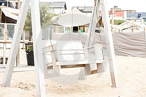 A swing on the beach near a lounge